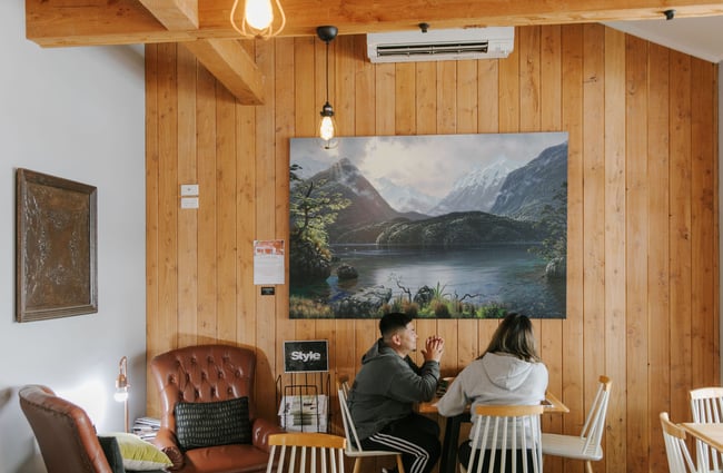 Two customers sitting at a table inside the Fairlie Bakehouse.