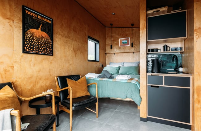 Wider view of the bed in Falcon Ridge cabin.