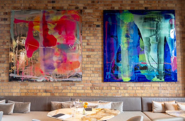 Close up of big and colourful abstract art pieces on wall at Faradays wine bar area
