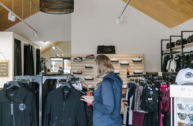 Woman browsing the clothes at Fearless, Wānaka.