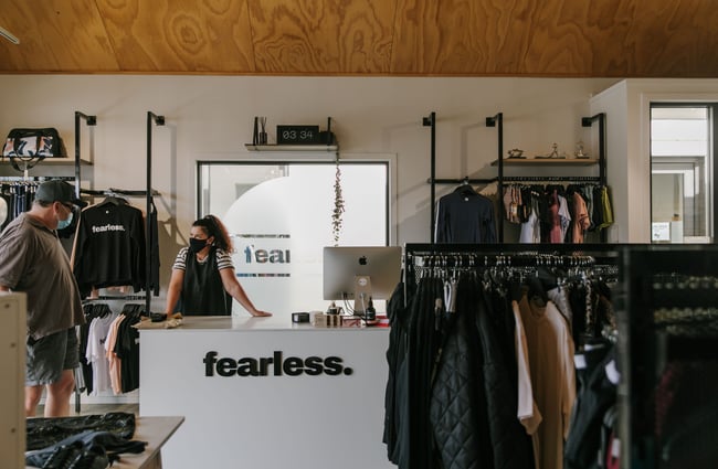 Woman chatting to customer at the till at Fearless, Wānaka.