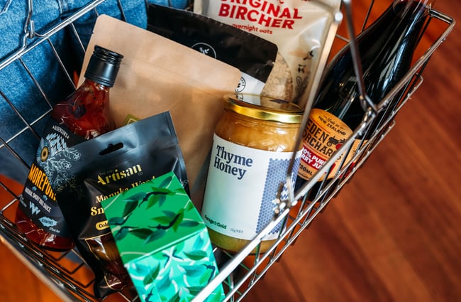 A close up of grocery items in a grocery basket.