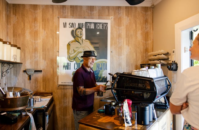 Barista behind the coffee machine at FEOH Espresso and Roastery.