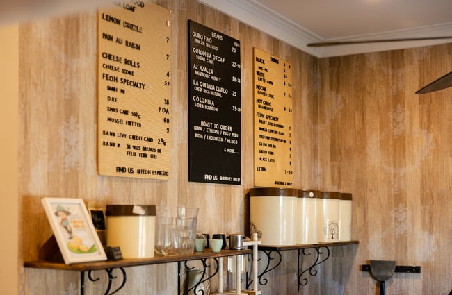 Menu signage on the wall at FEOH Espresso and Roastery.