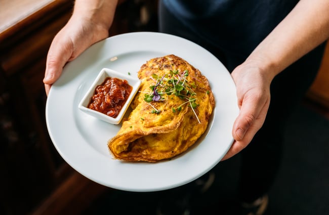 A large omelette on a plate.