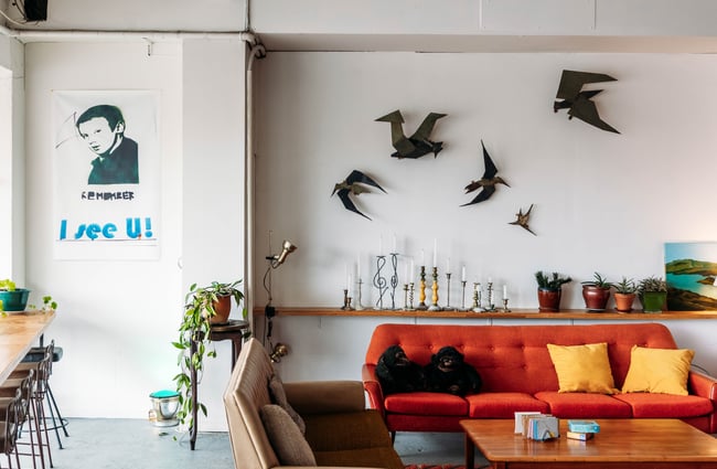 Couch seating area with bird sculptures on the wall behind at Firebird Cafe.