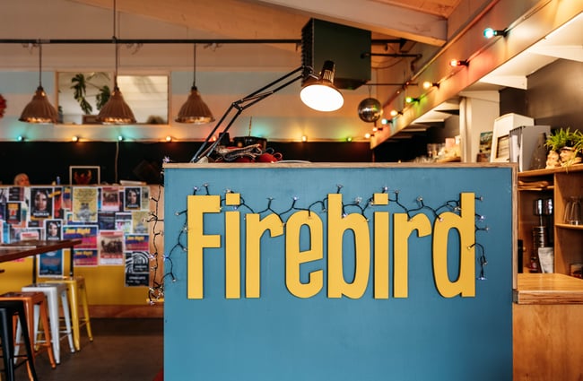 Front counter and tables behind at Firebird Cafe.