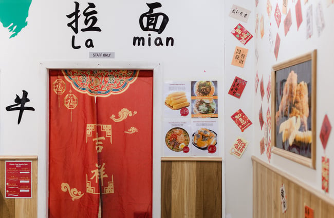 Red doorways and decorations on the wall at FJ Noodles & Dumplings.