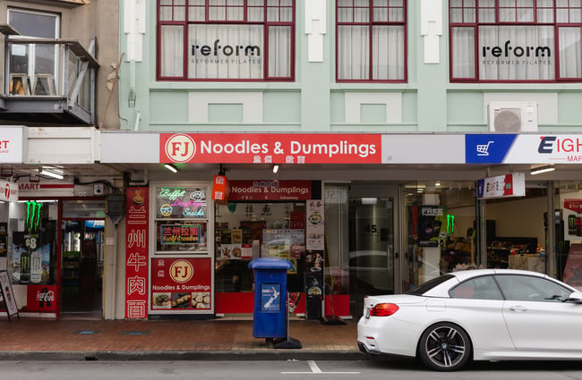 Bright red exterior of FJ Noodles & Dumplings.