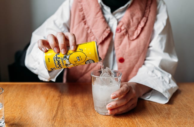 A lemonade being poured into a glass.