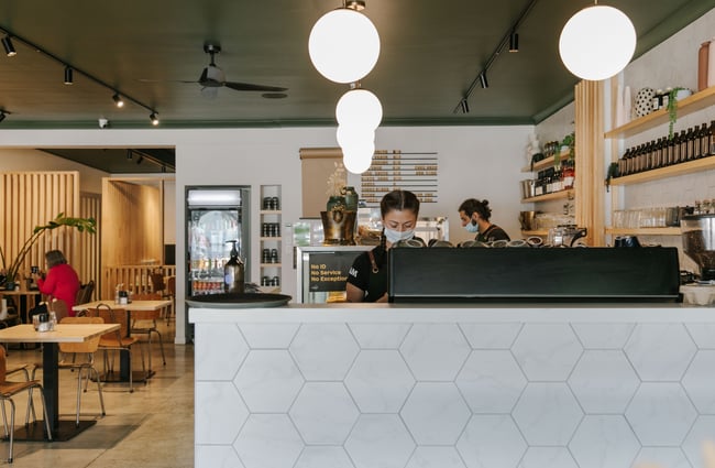 Barista at the coffee machine at Flo & Co.