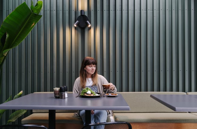 Woman about to take a sip of coffee.
