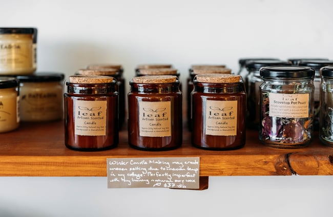 A close up jars on a shelf.