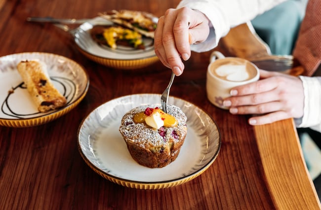 A close up of a muffin and coffee.