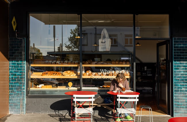 A customer dining outside Florets Bakery Auckland on a sunny day.