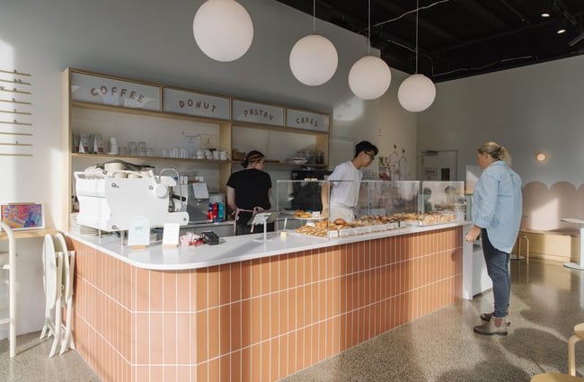Customers ordering at the counter at Fluffy Bake Shop.