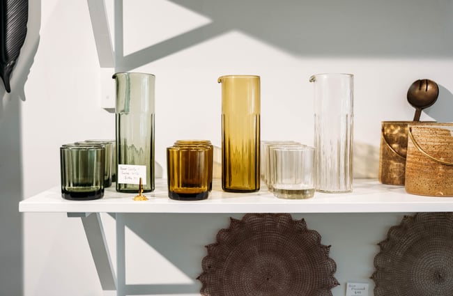 Colourful glassware on shelves.