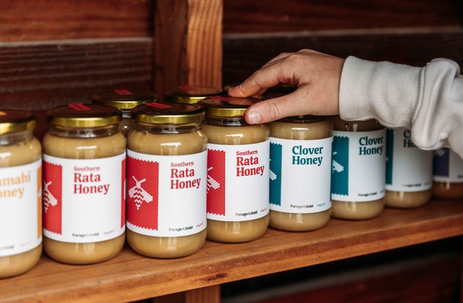 Lineup of honey on the shelf in the shed at Forage & Gold.
