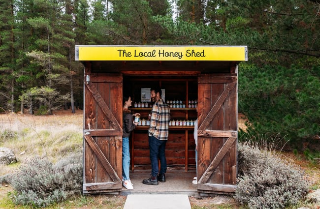 Customers standing inside the honey shed of Forage & Gold.
