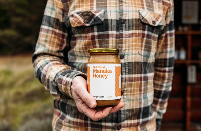 Customer holding a jar of honey at Forage & Gold.
