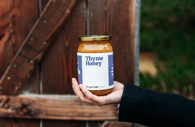 Customer holding a jar of honey at Forage & Gold.