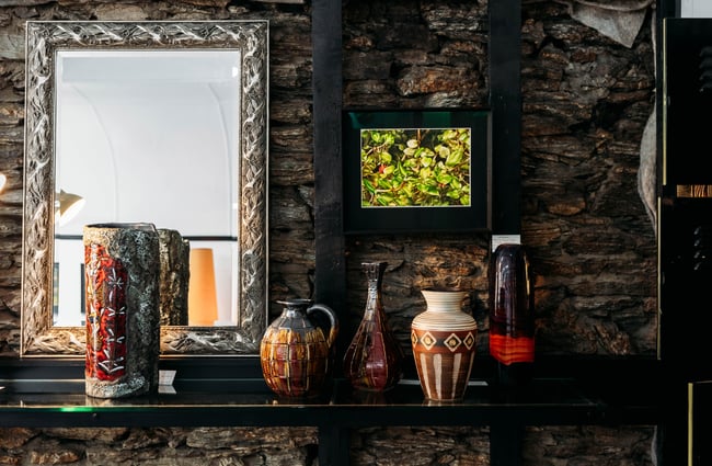 Large brown vases on shelves.
