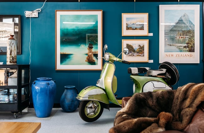 Vintage scooter and furniture inside a retail store.