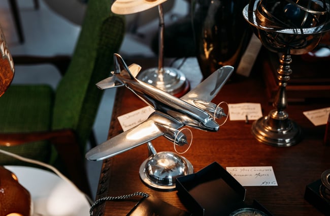 A silver plane sculpture.