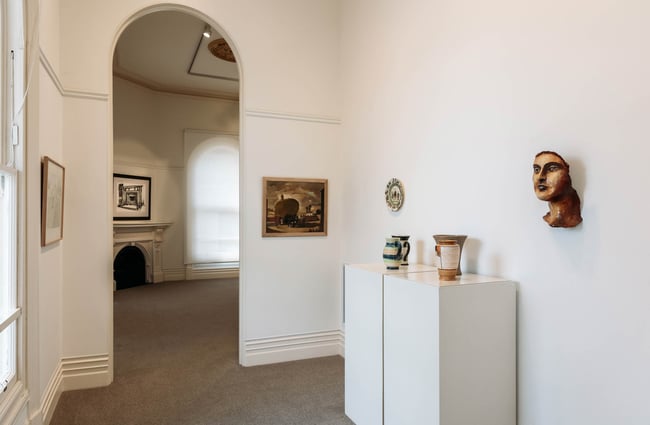 Upstairs exhibition space at Forrester Gallery with tall arched doorways