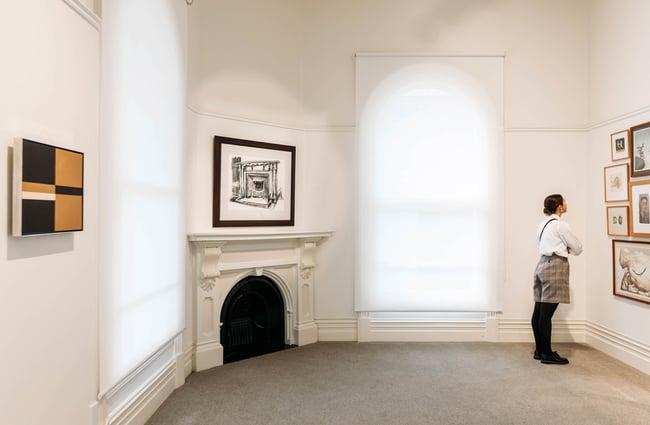 Woman looking at artwork in Forrester Gallery exhibition space