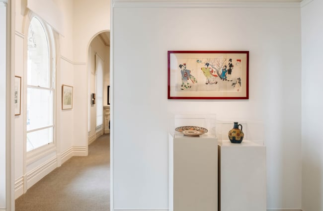 Upstairs exhibition space at Forrester Gallery highlighting Japanese artwork and ceramics in glass cases