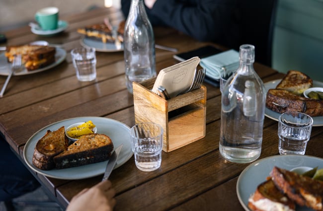 Toasted sandwiches on a wooden table.