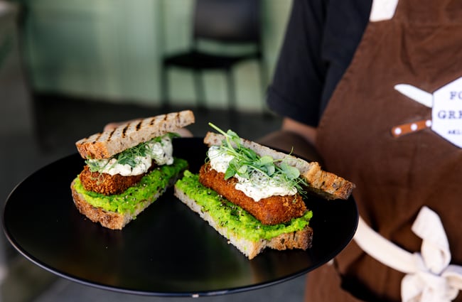 A close up of huge sandwiches on a plate.