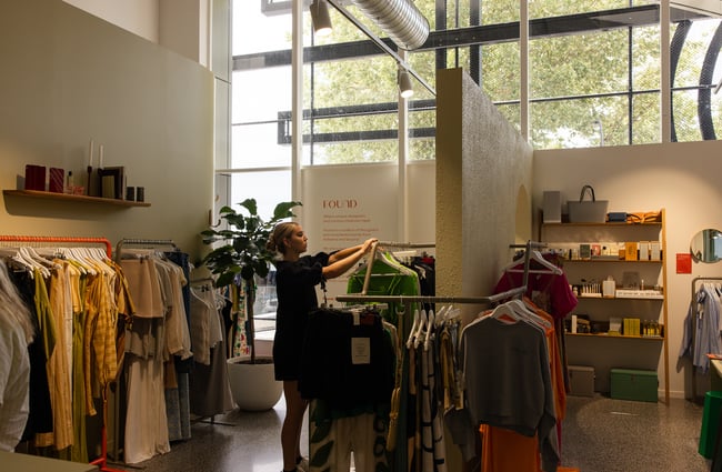 Customer holding up an item of clothing at FOUND.