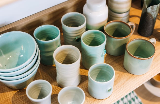 An extreme close up of green and blue glazed cups.