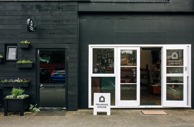 The black and white entrance to The Framing House.
