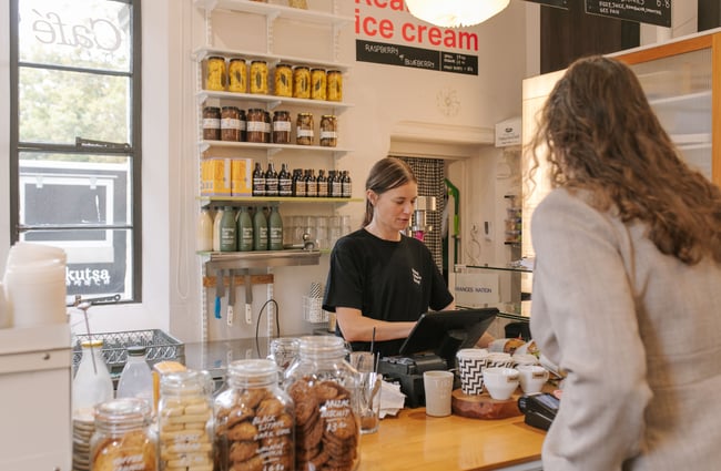 Shop assistant serving a customer at Frances Nation Café.