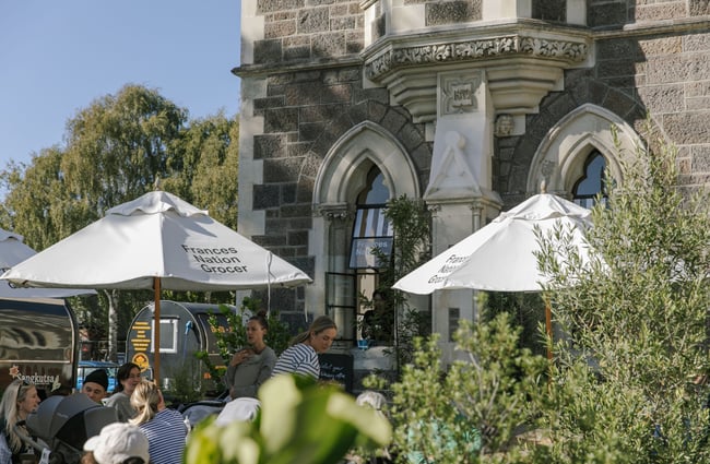 Customers dining under umbrellas at Frances Nation cafe.