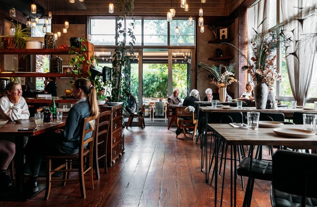 Customers sitting at tables in the dining room at Francesca.
