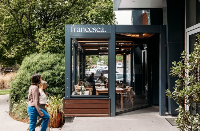 Two customers walking into the building at Francesca.
