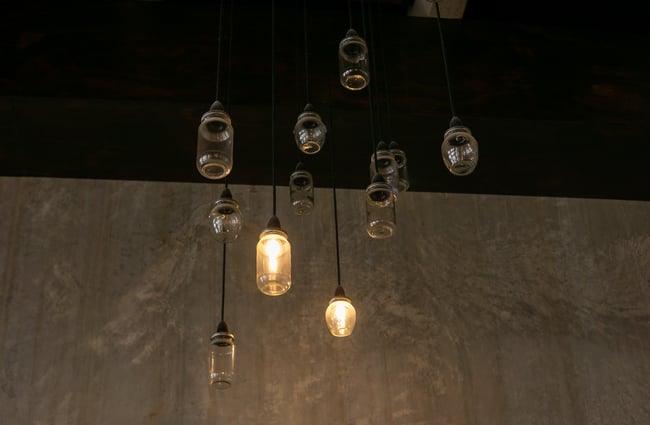 A close up of lights hanging from a ceiling.