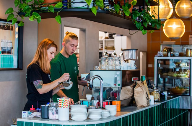 Baristas behind the espresso machine at Frank.