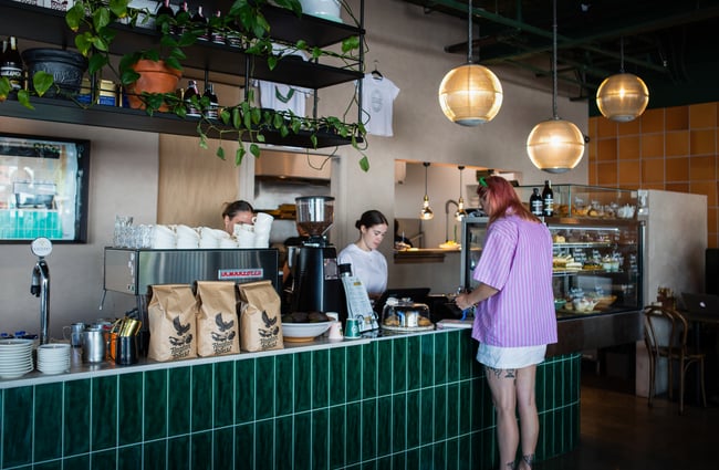 Customer ordering at the counter at Frank.