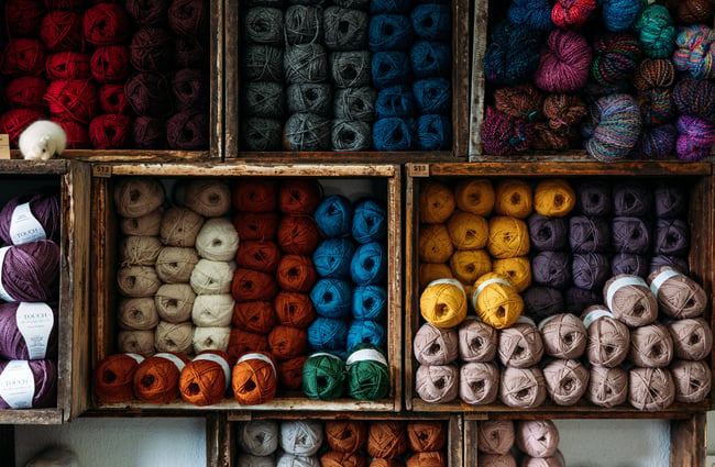 A close up of colourful balls of wool.