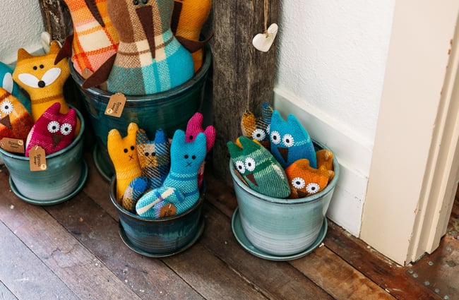 Soft toys in baskets on the floor.