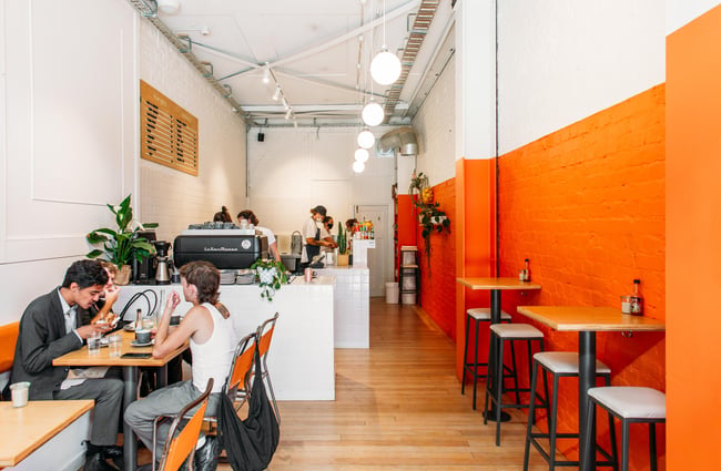 Interior view of Fred's with customers dining at a table.
