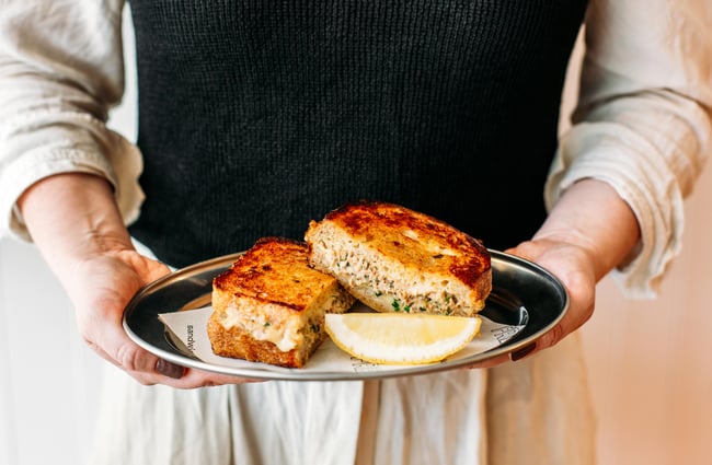 Man holding a tuna melt toastie from Fred's, Wellington.