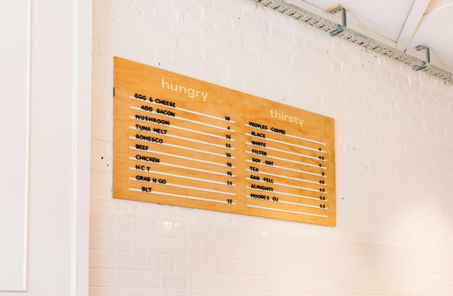 Plywood menu mounted on the wall at Fred's, Wellington.