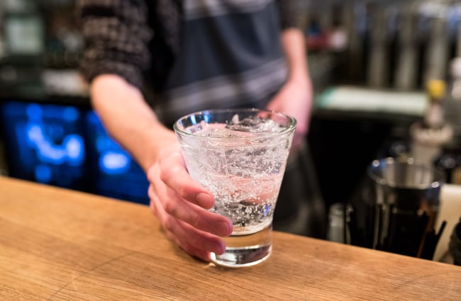 Bartender putting a drink up on the counter.