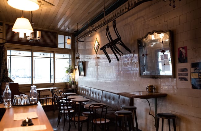 Chairs hanging from wall.
